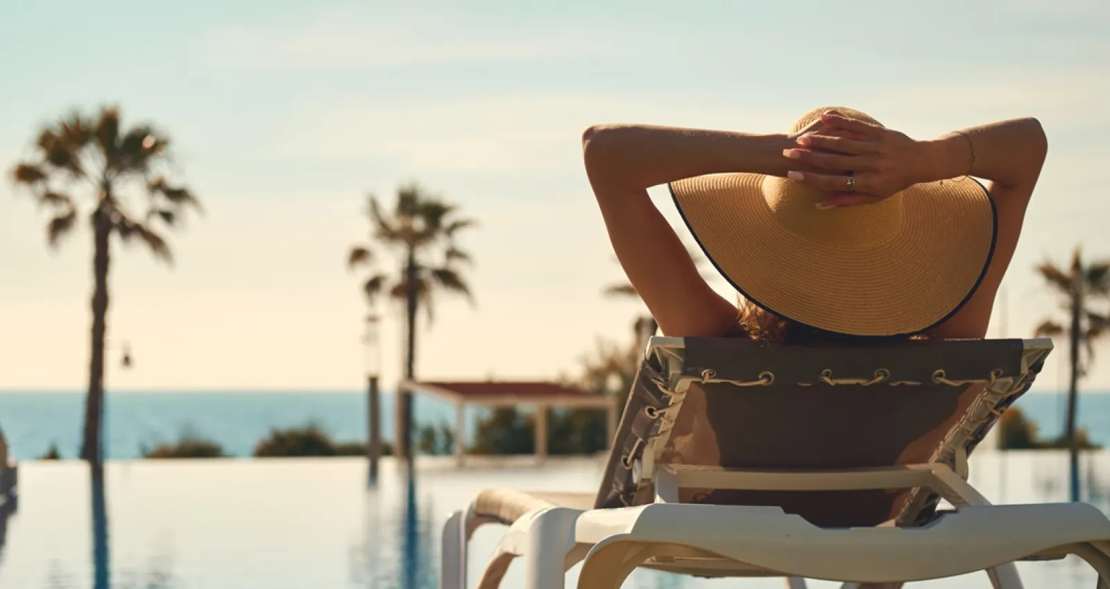 Foto de una mujer de espaldas mirando la playa