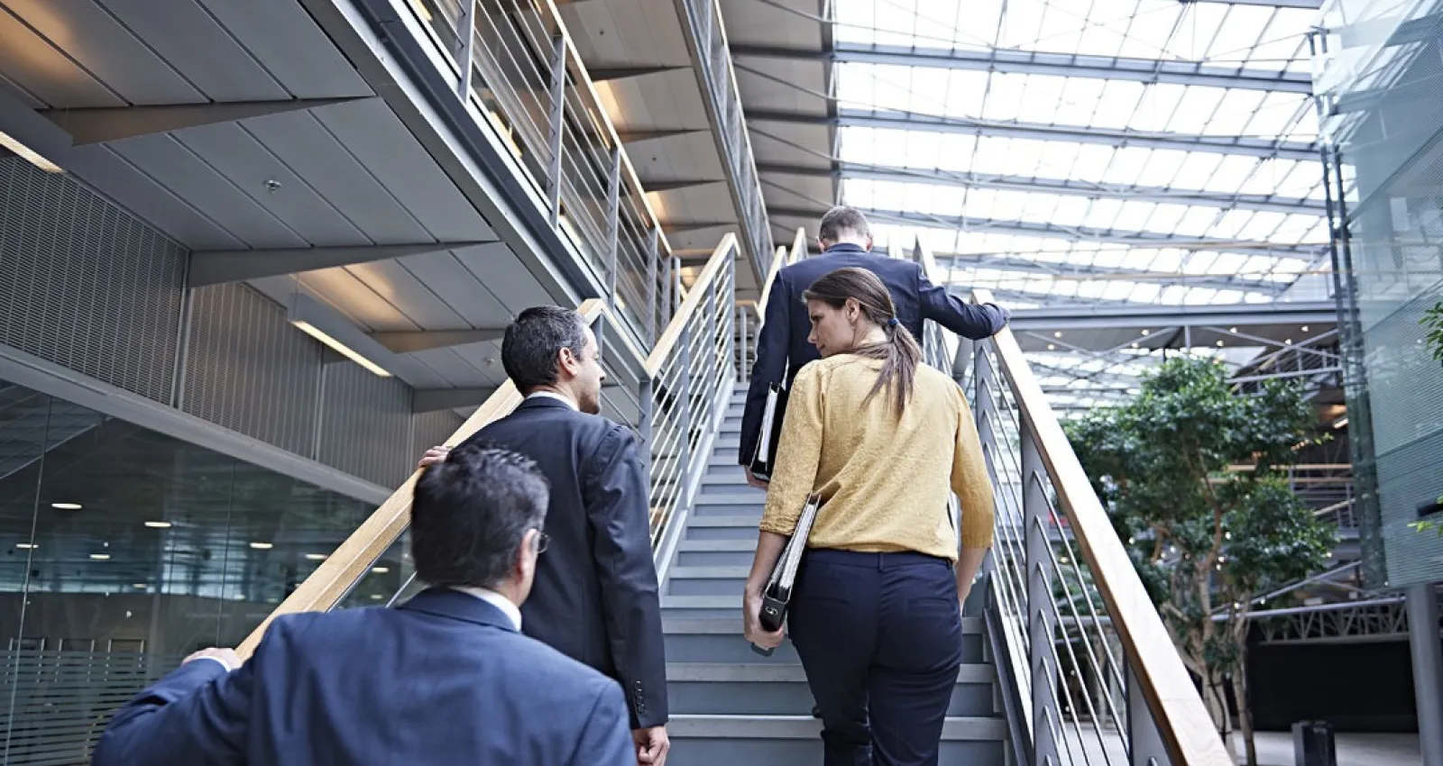 Foto de tres personas subiendo una escalera