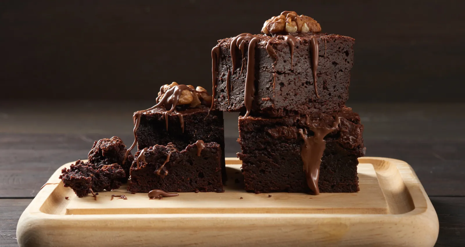 Torta de chocolate sobre una tabla de madera con un fondo negro
