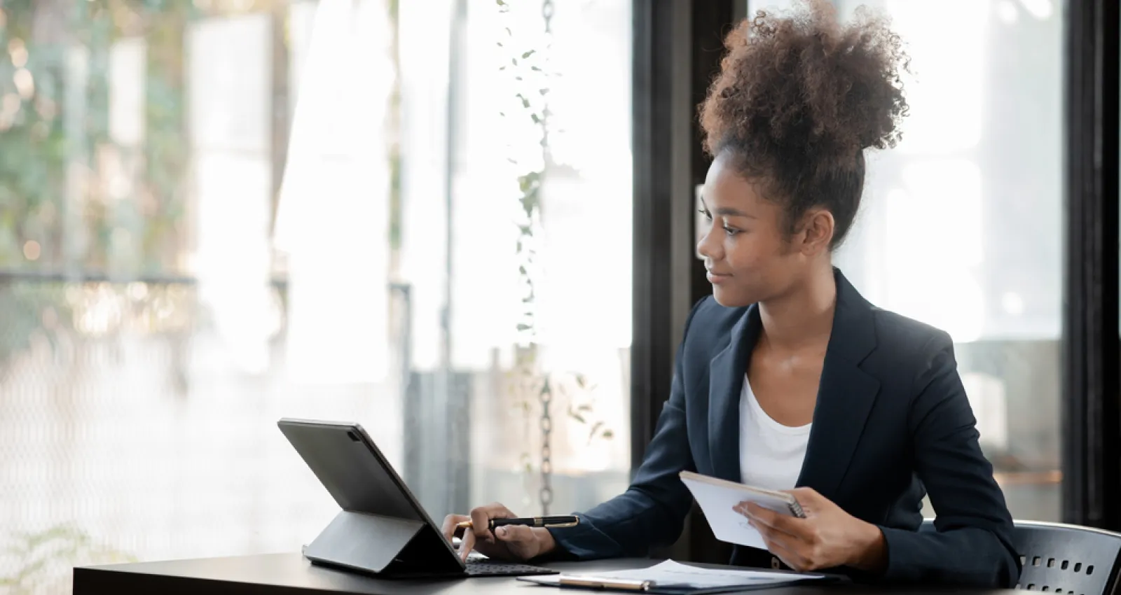 Mujer afro sentada en un escritorio