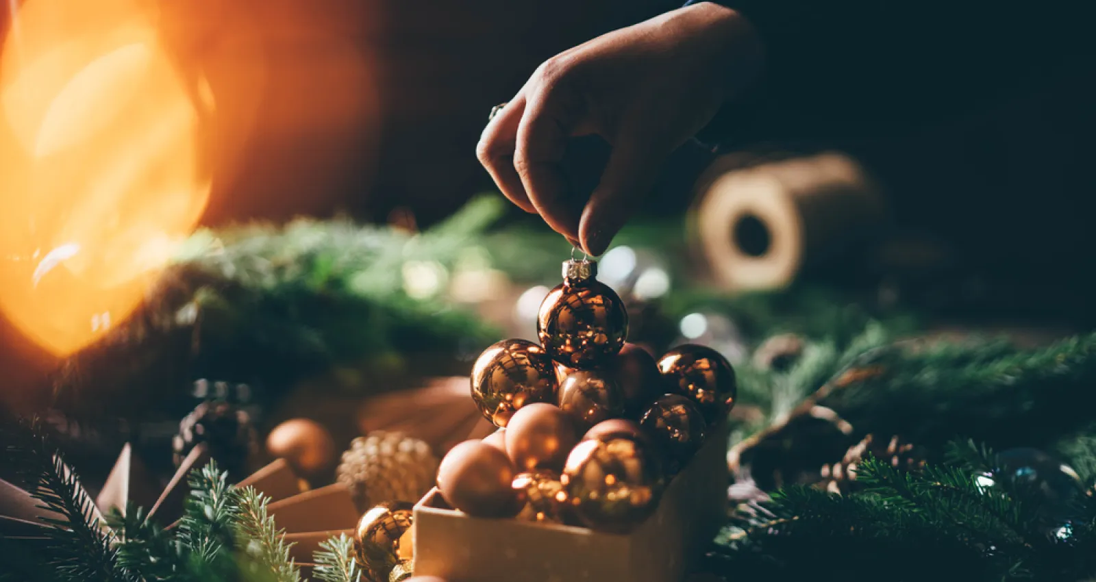 Foto de una foto de navidad, de una persona poniendo una bola de navidad en un canasto