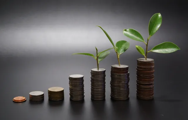 Foto de monedas apiladas de forma creciente  con un fondo gris