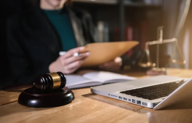 Escritorio con un computador y una imagen representativa de la justicia